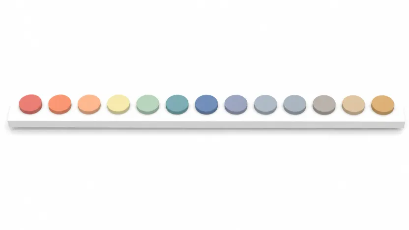 A row of colour swatches on a shelf, vivid at one end and fading into muted greys and browns at the other.
